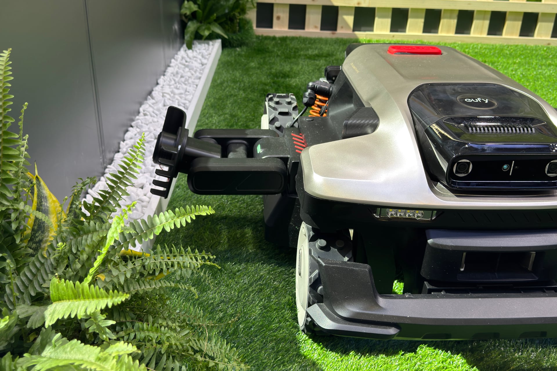 Close-up of the Eufy Lawn Mower S2 Max with its trimming arm extended and aligned vertically for edging.