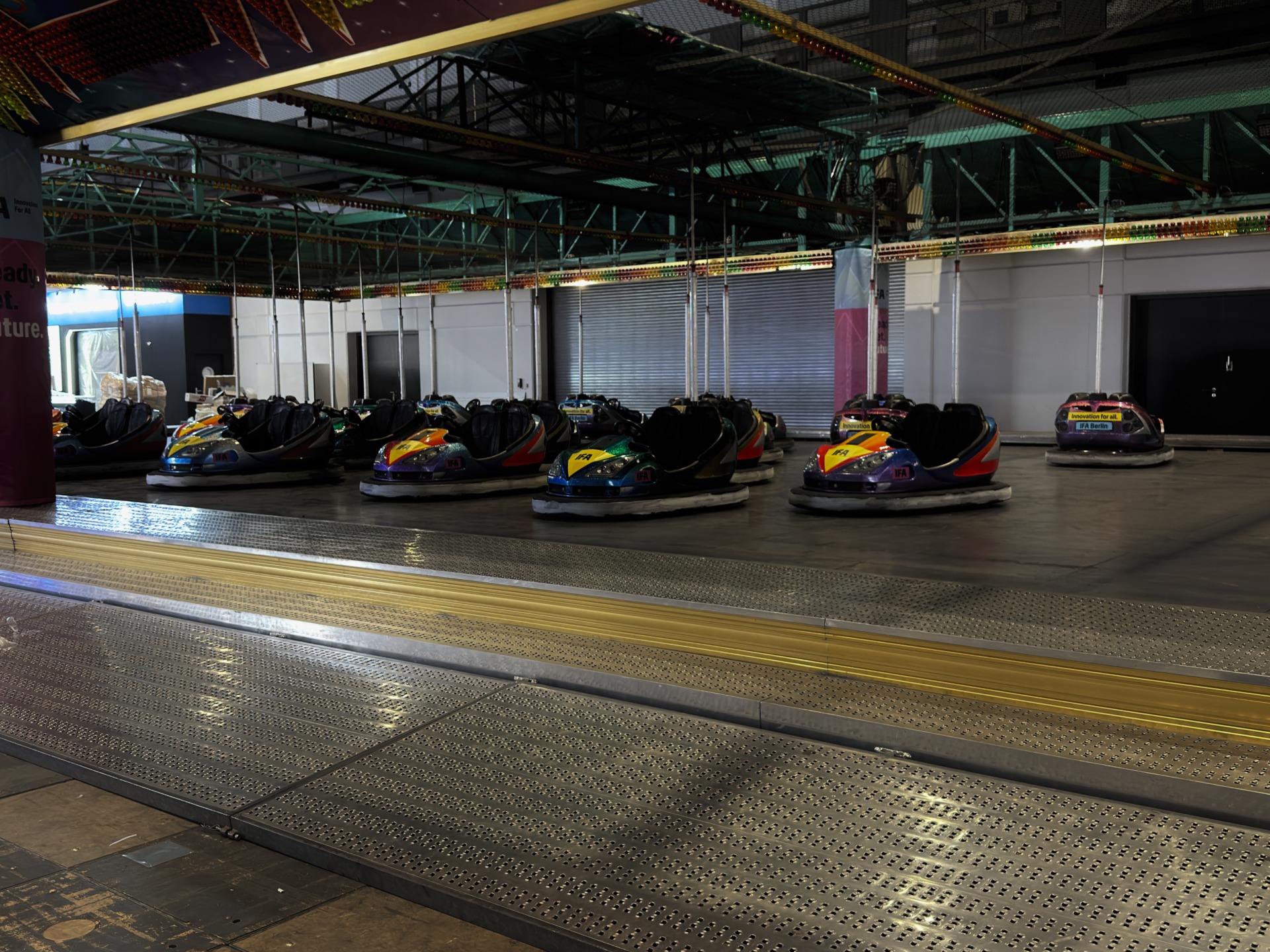 A picture of bumper cars in a dark room