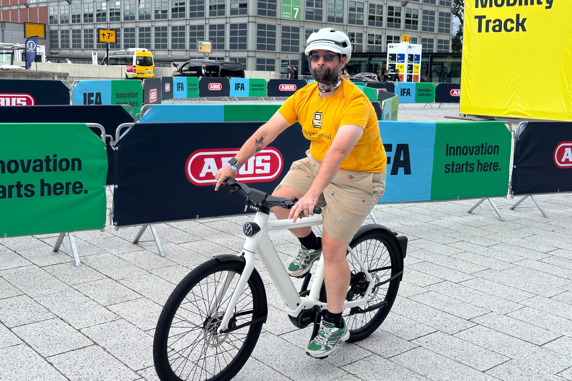 Person riding the Volkswagen e-bike and making a goofy face at the camera.