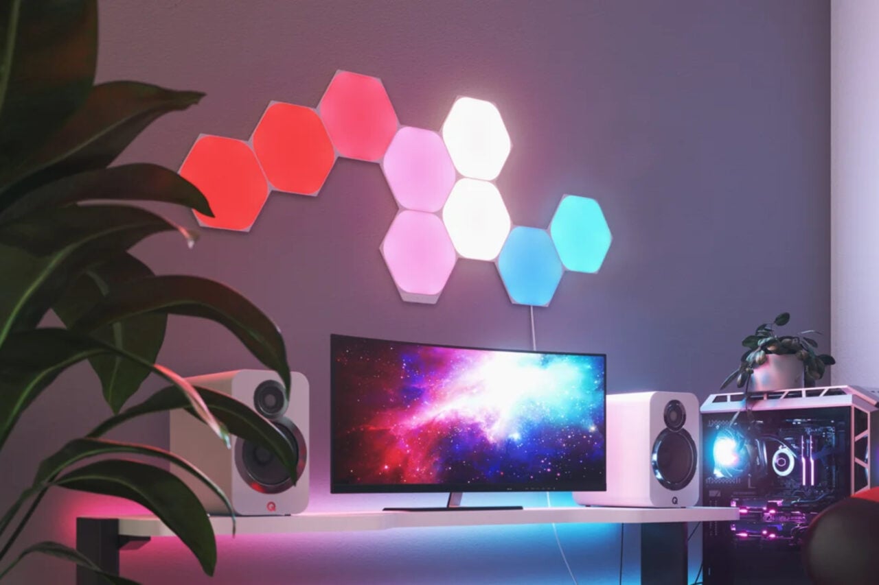 Nanoleaf shapes panels on a wall above a PC setup.