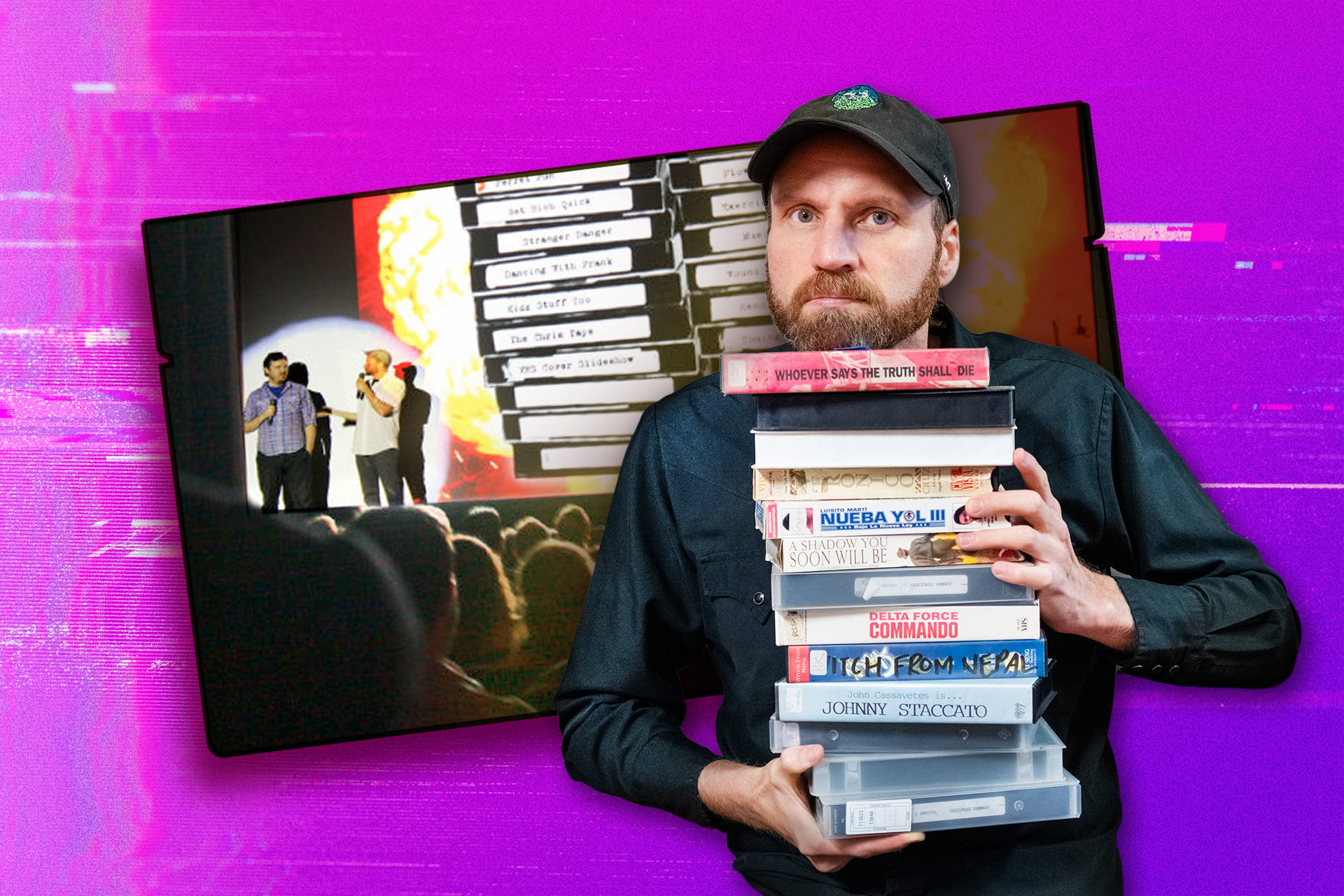 Nick Prueher posing with his collection of VHS tapes.