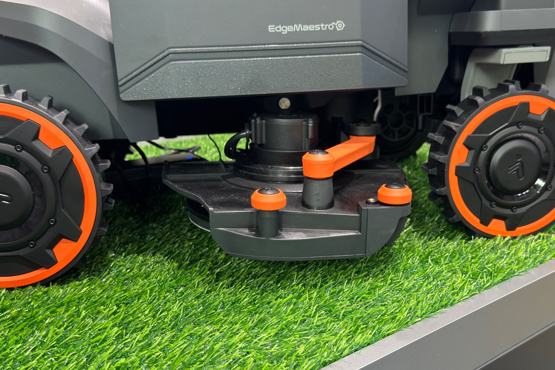 Segway Navimow H5 Pro with its side open and mowing blade slid out.