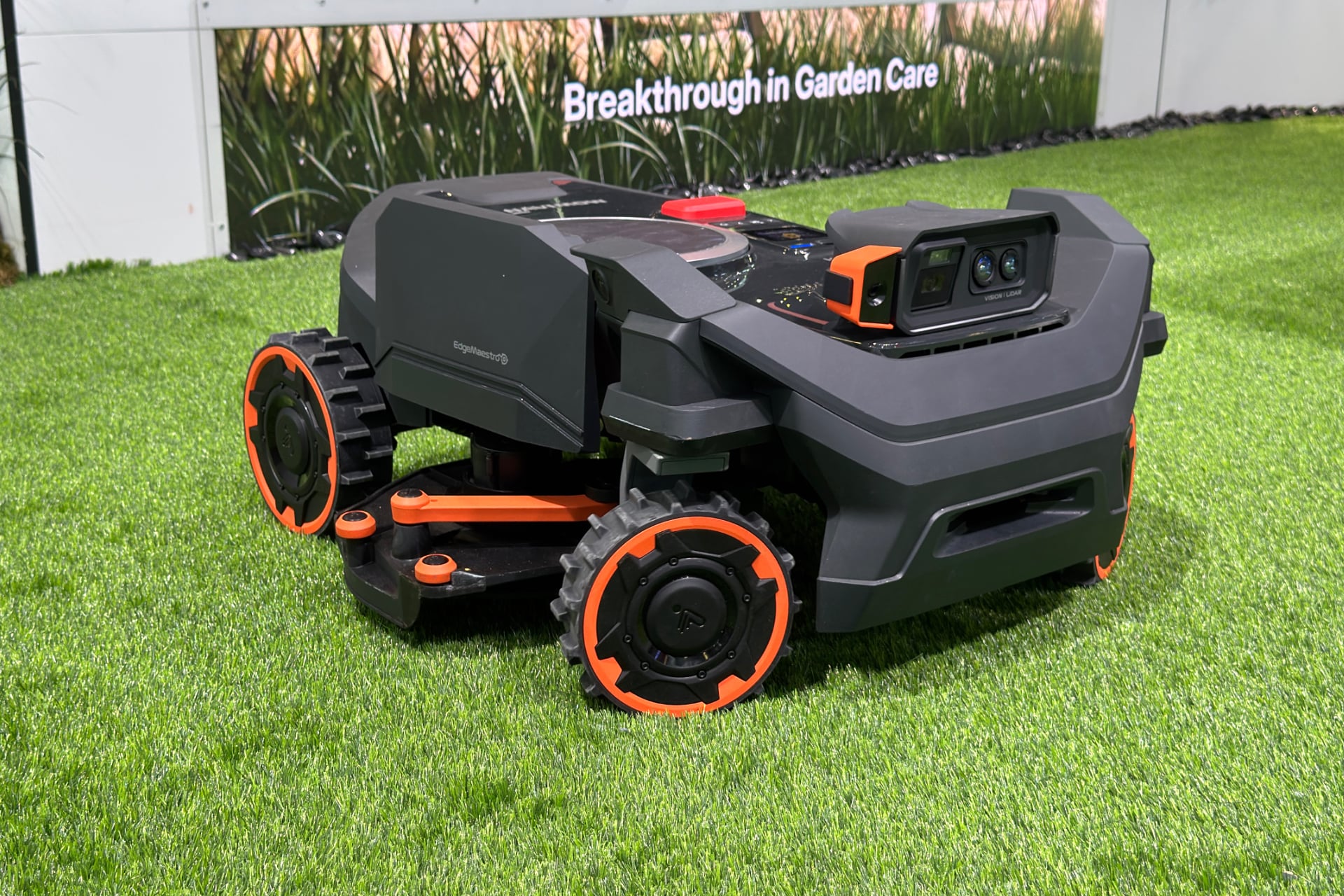 Segway Navimow H5 Pro pictured with its cutting blade extending out from beneath its body.