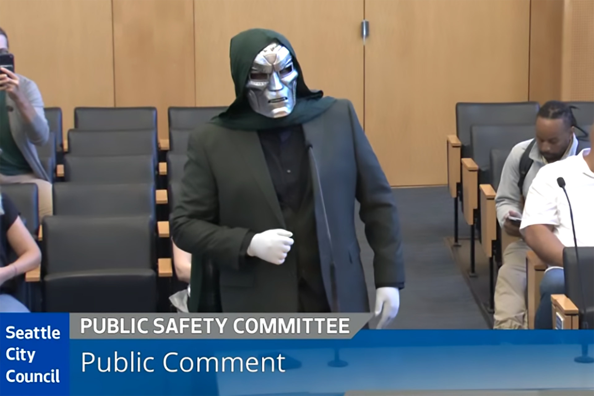 A man dressed as Marvel's Dr. Doom speaks at a Seattle City Council meeting.