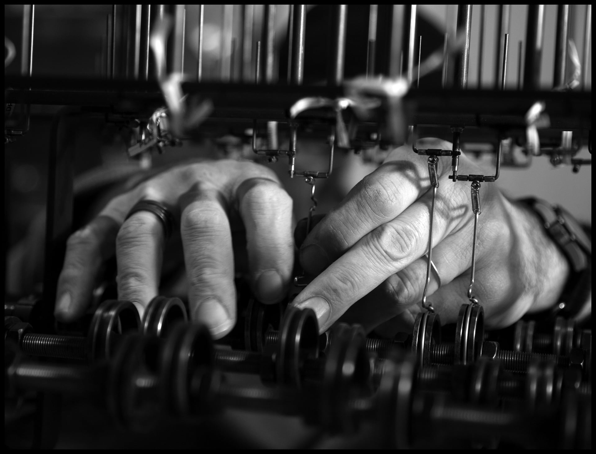Photo of Arthur Ganson's hands working through gears