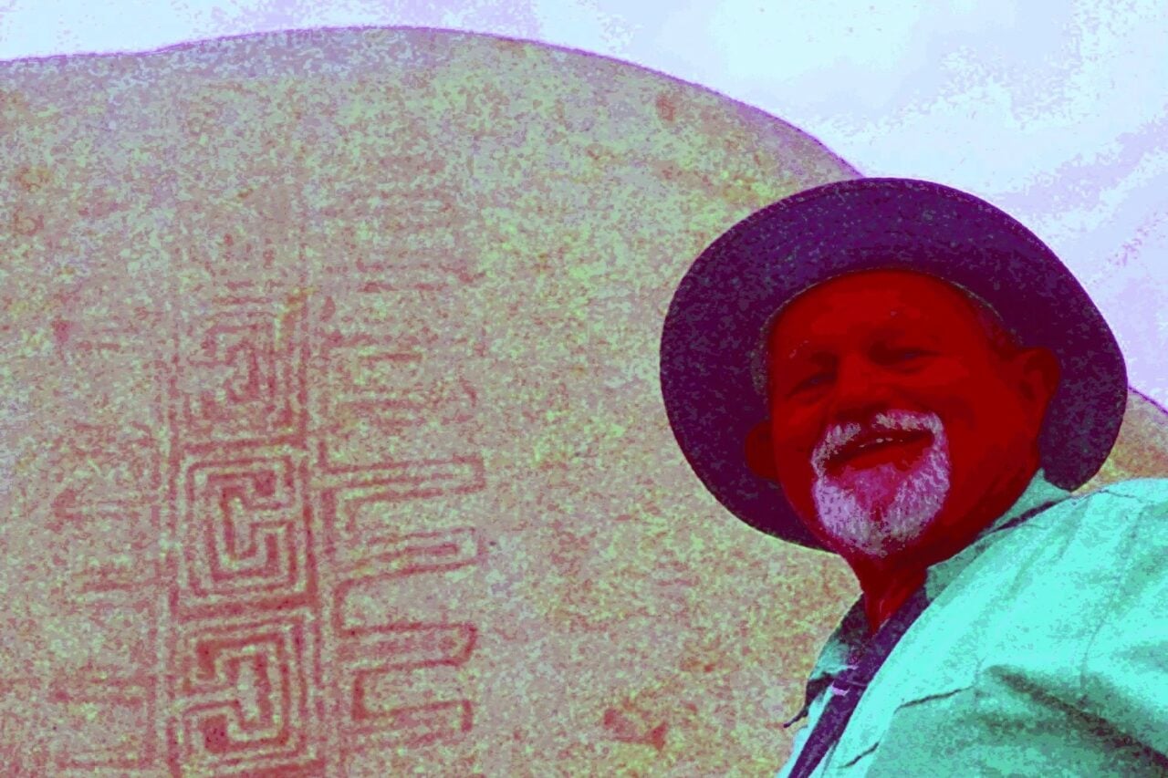Jon Harman poses in front of an example of the Rancho Bernardo style of Native American artwork that’s barely visible until Dstretch is applied.