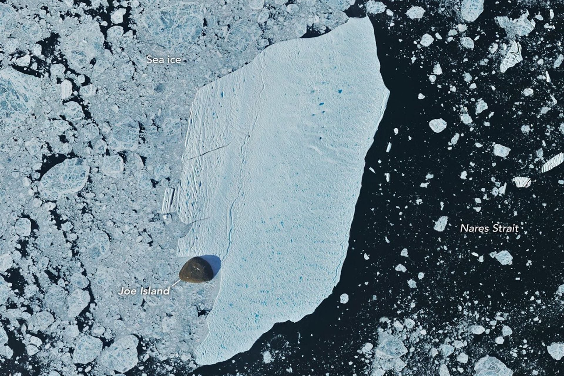 NASA-USGS Landsat satellites captured this image of the ice island as it drifted toward Nares Strait.