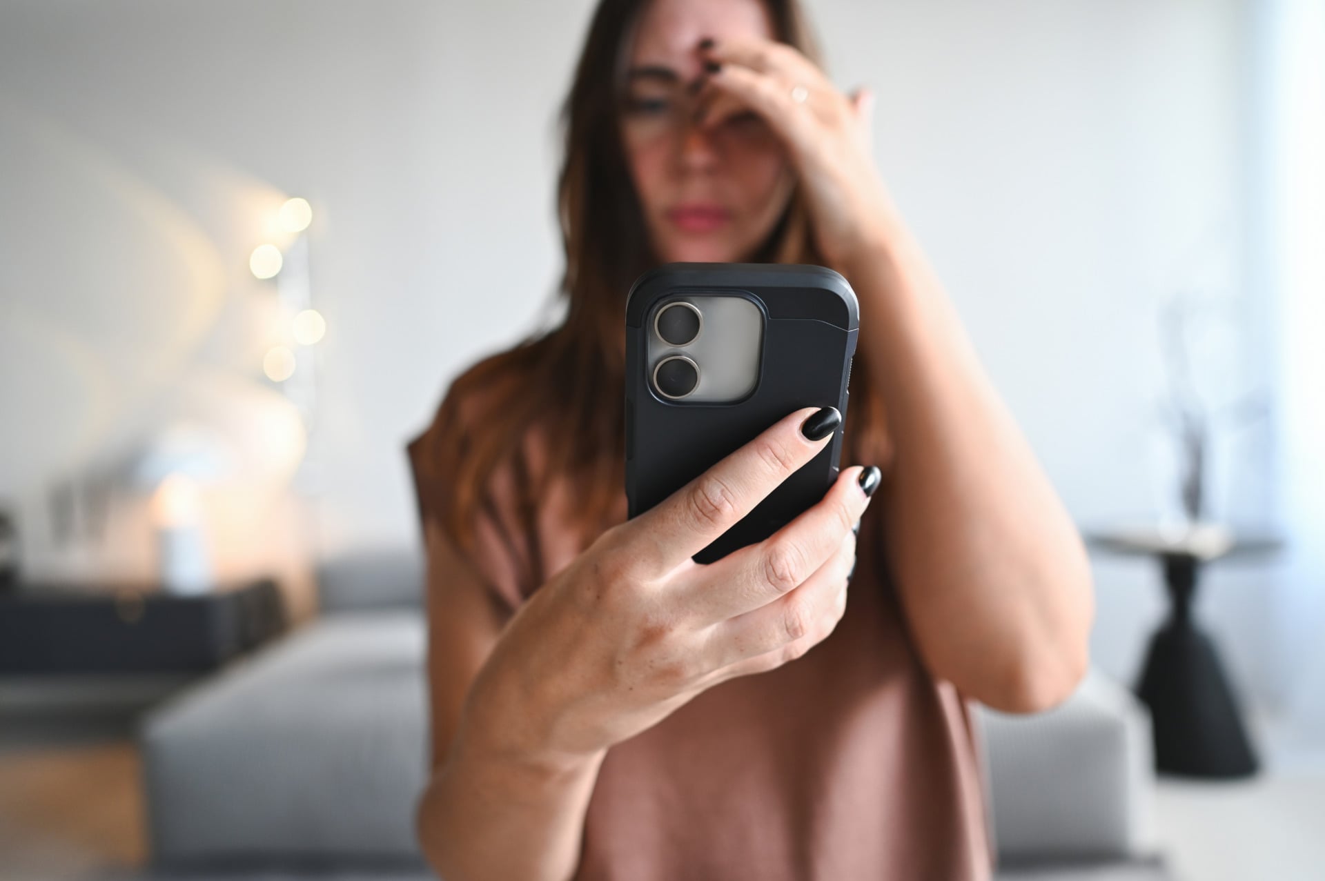 Woman looking at phone stressed out