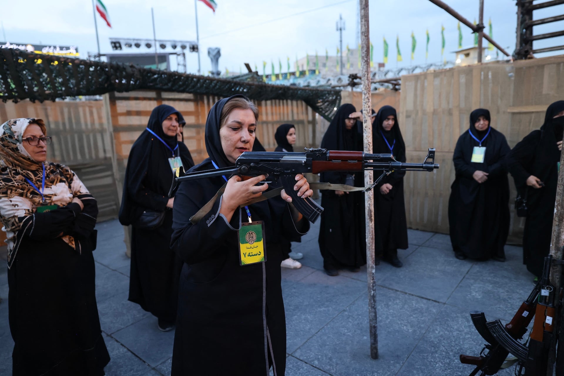 An Iranian woman holds a weapon during a military course for volunteers at the Janfada ("Sacrifice for the Homeland") training camp set up in Imam Hussein square in Tehra on October 6, 2026.