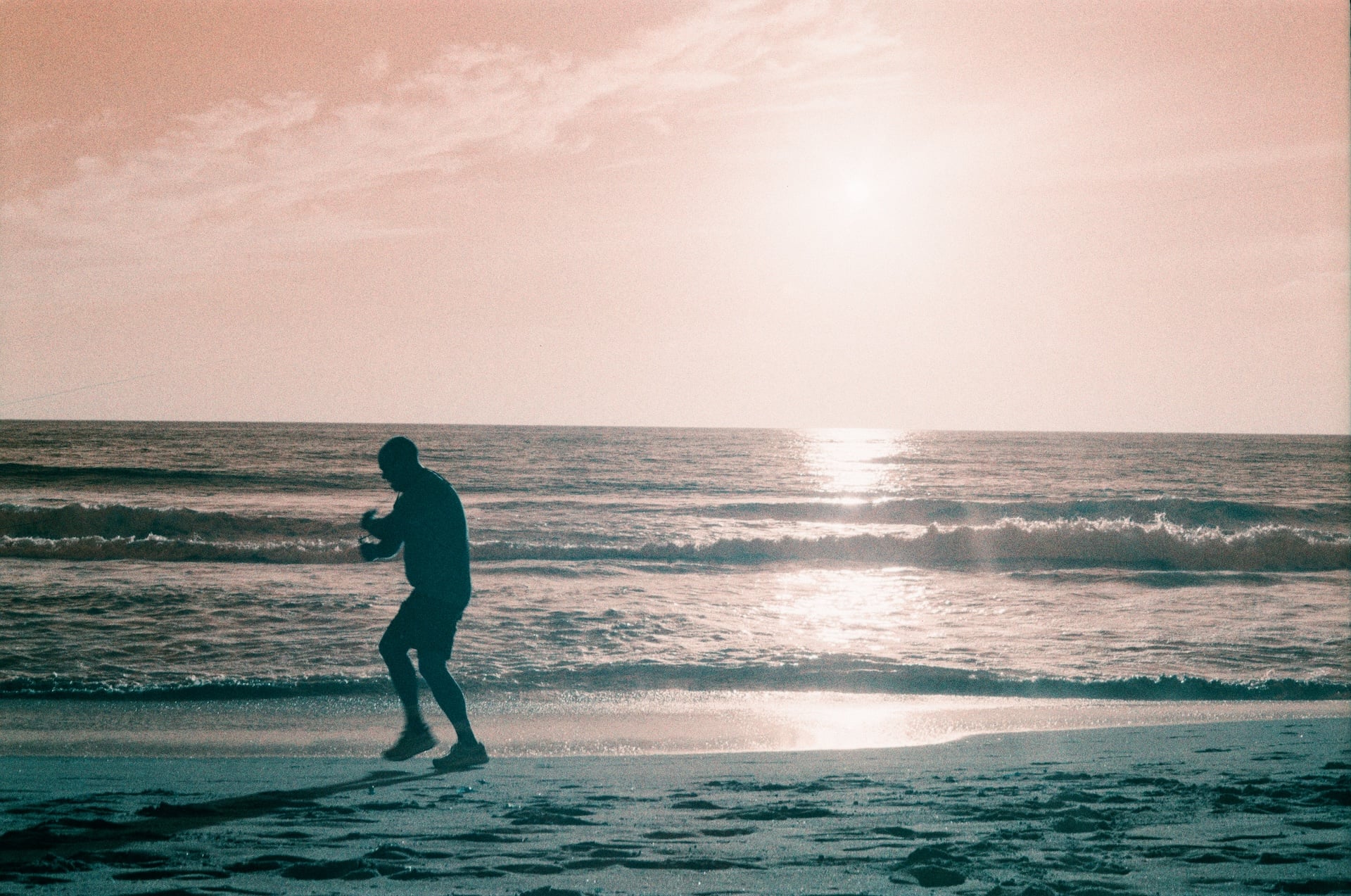 A man jogs on Del Mar Beach in Del Mar, California.