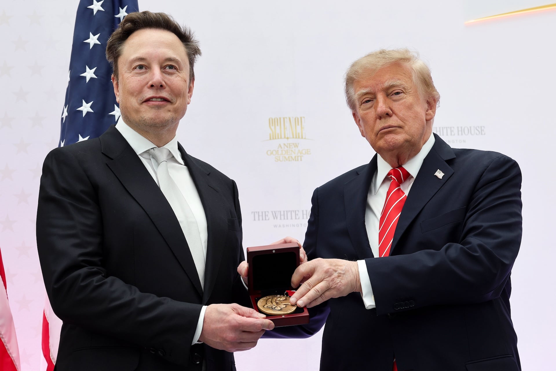 Tesla and SpaceX CEO Elon Musk (L) receives the National Medal of Science from U.S. President Donald Trump during the Golden Age of American Innovation Summit at the Institute of Peace on October 08, 2026 in Washington, DC.  