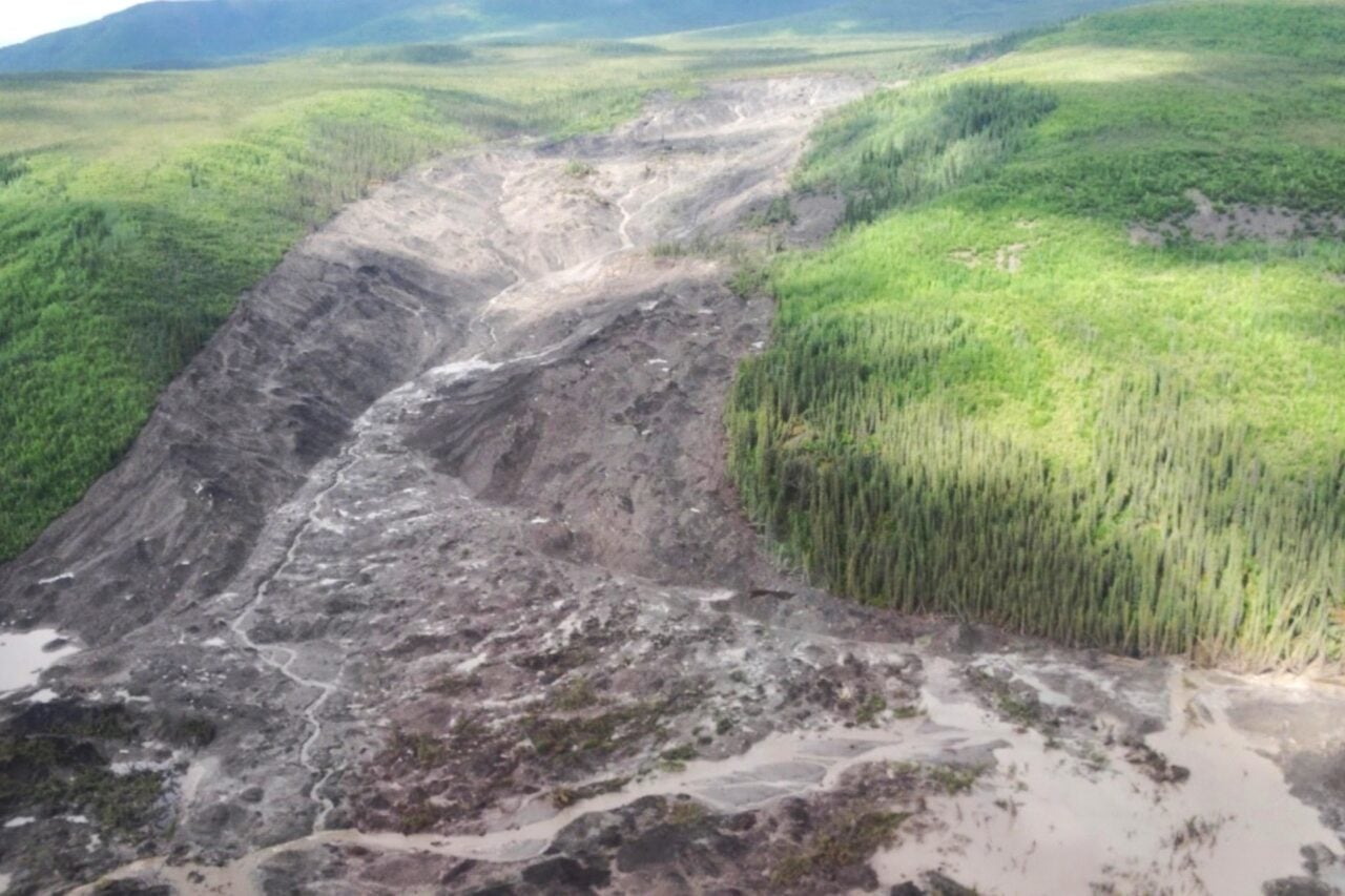 A grassy arctic landscape scarred by a huge landslide